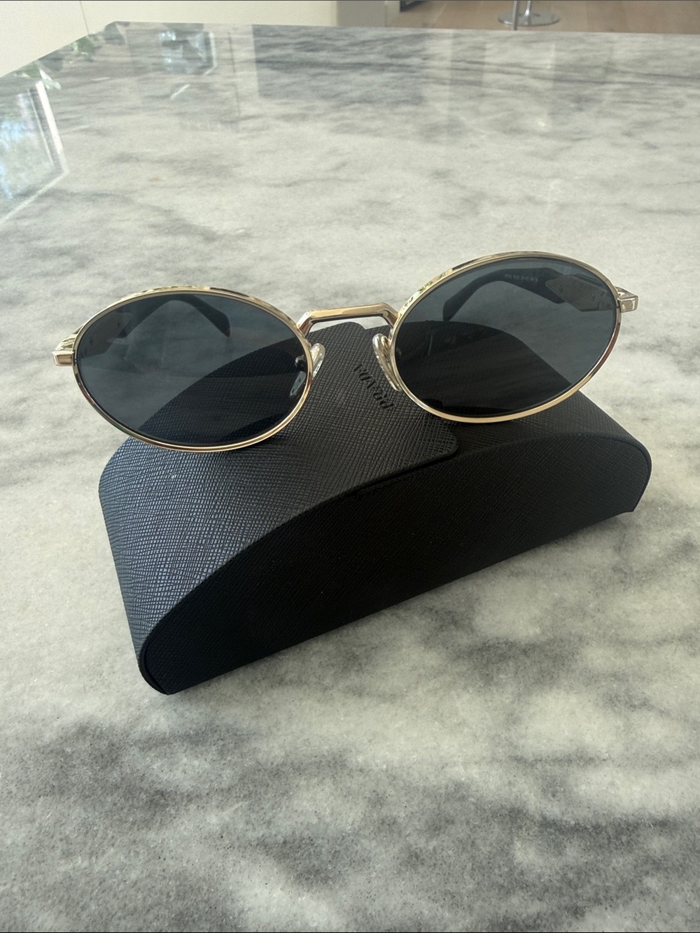 Prada Gold Frame Black Lens Oval Sunglasses